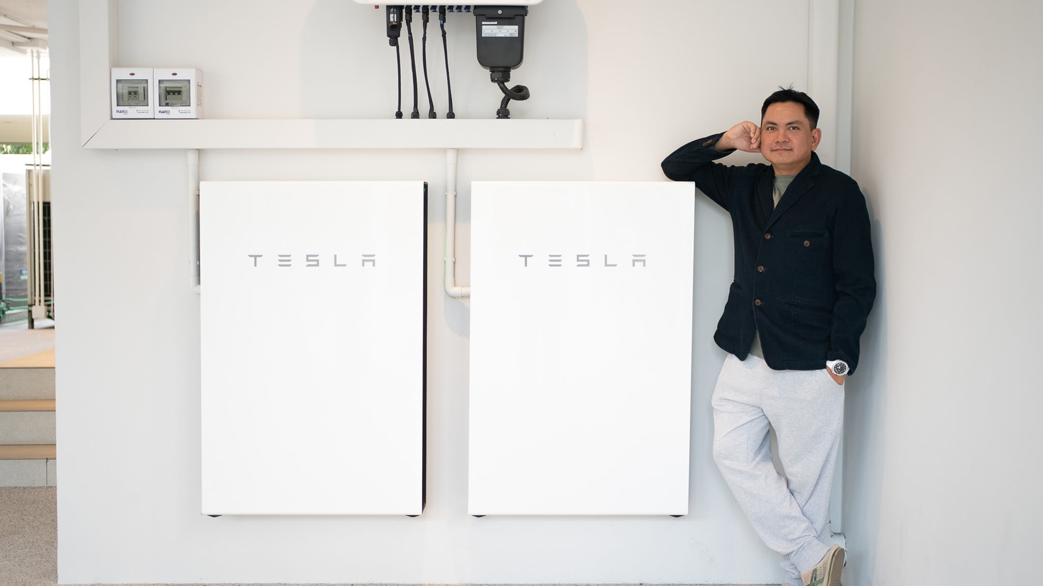 Man standing next to Tesla Powerwall