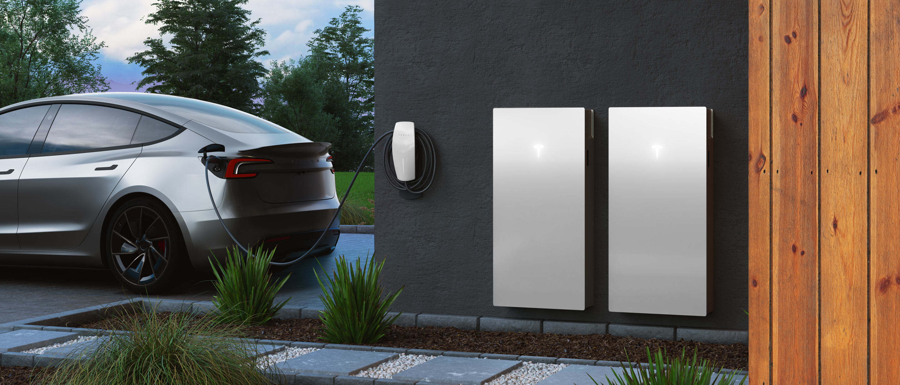 An aerial of a home with solar panels and a parked white Tesla vehicle