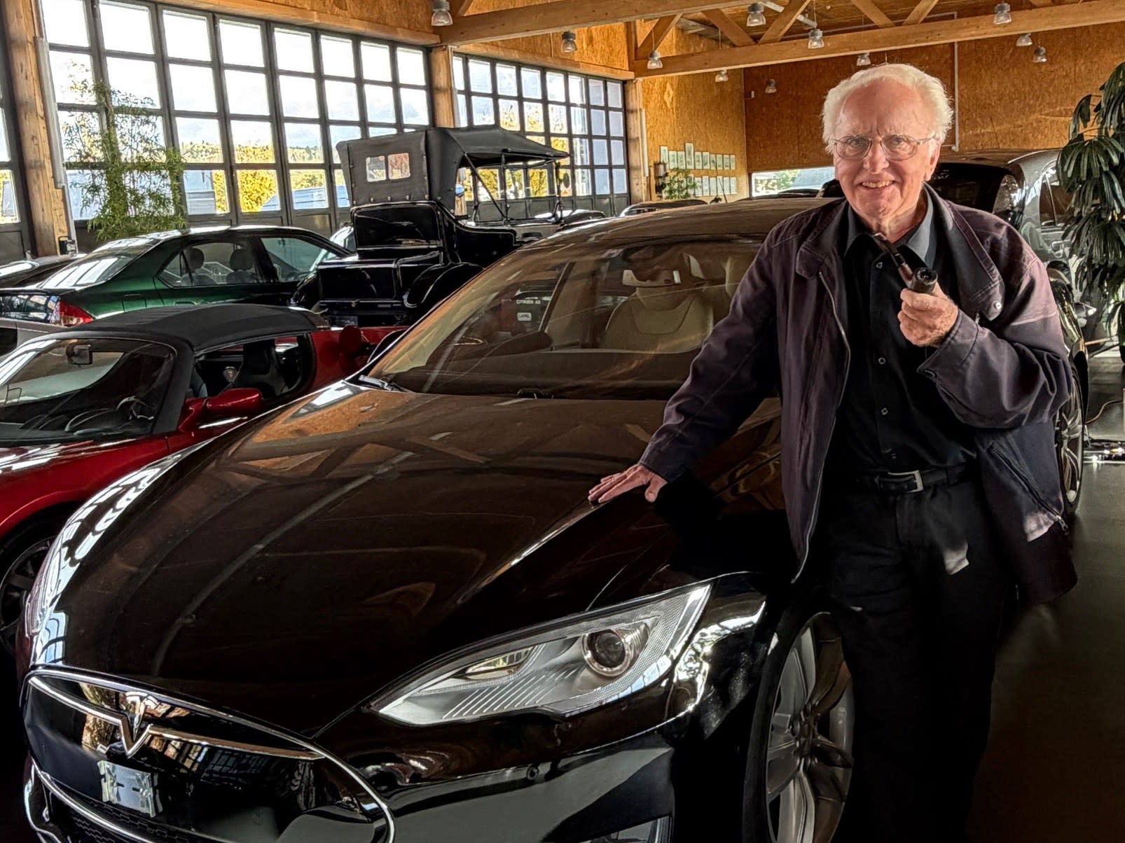 Hanspeter Setz standing next to his black Model S vehicle