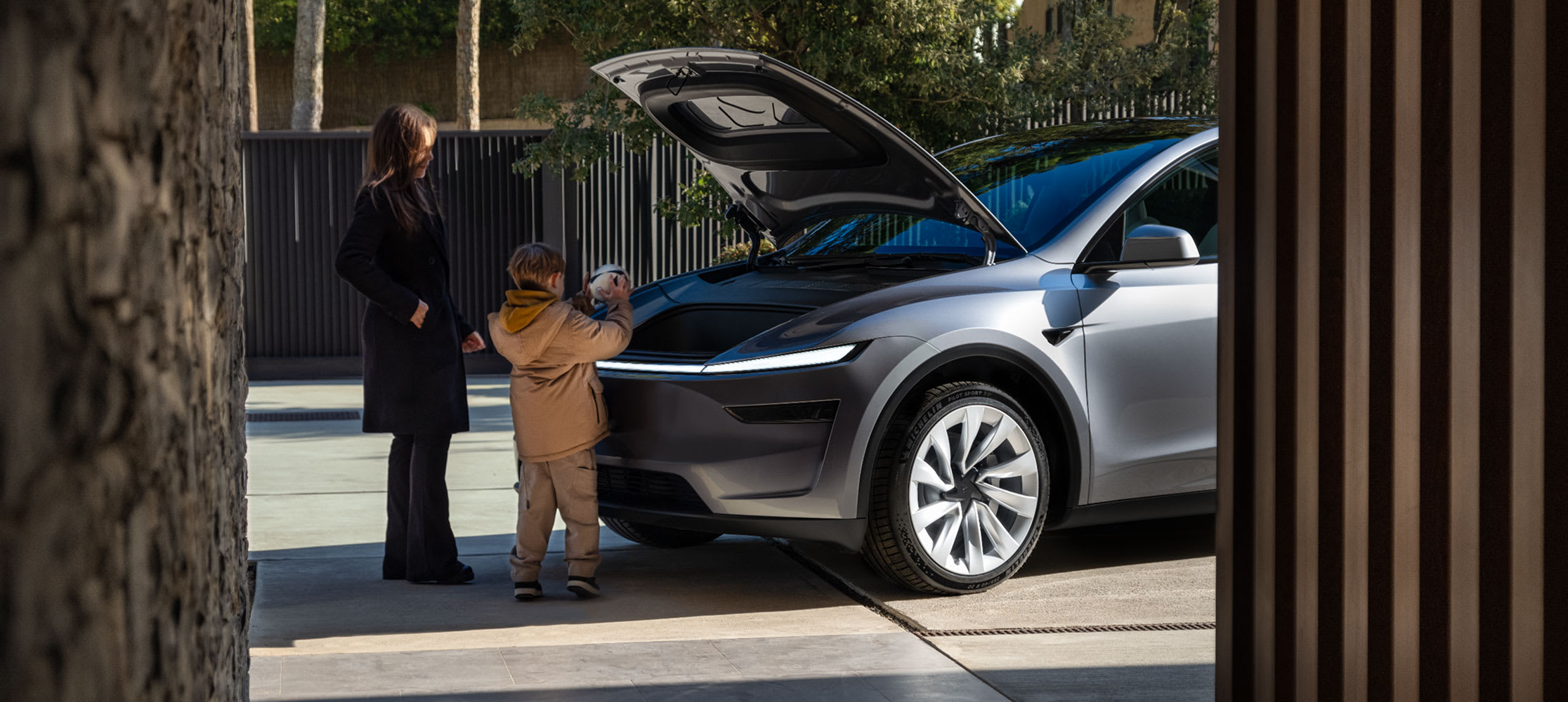 Family taking items from trunk of Model Y 