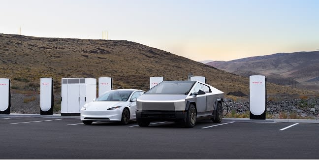A white Model 3 and a Cybertruck charging at Superchargers in a parking lot surrounded by mountains