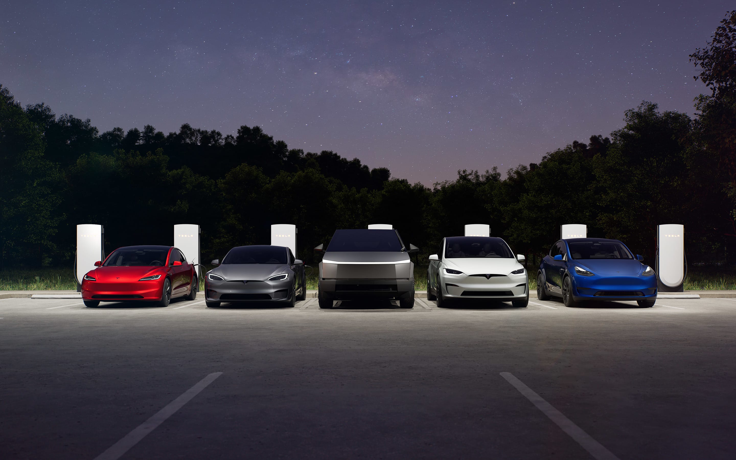 Model 3, Model S, Cybertruck, Model X and Model Y Supercharging in a parking lot during early evening