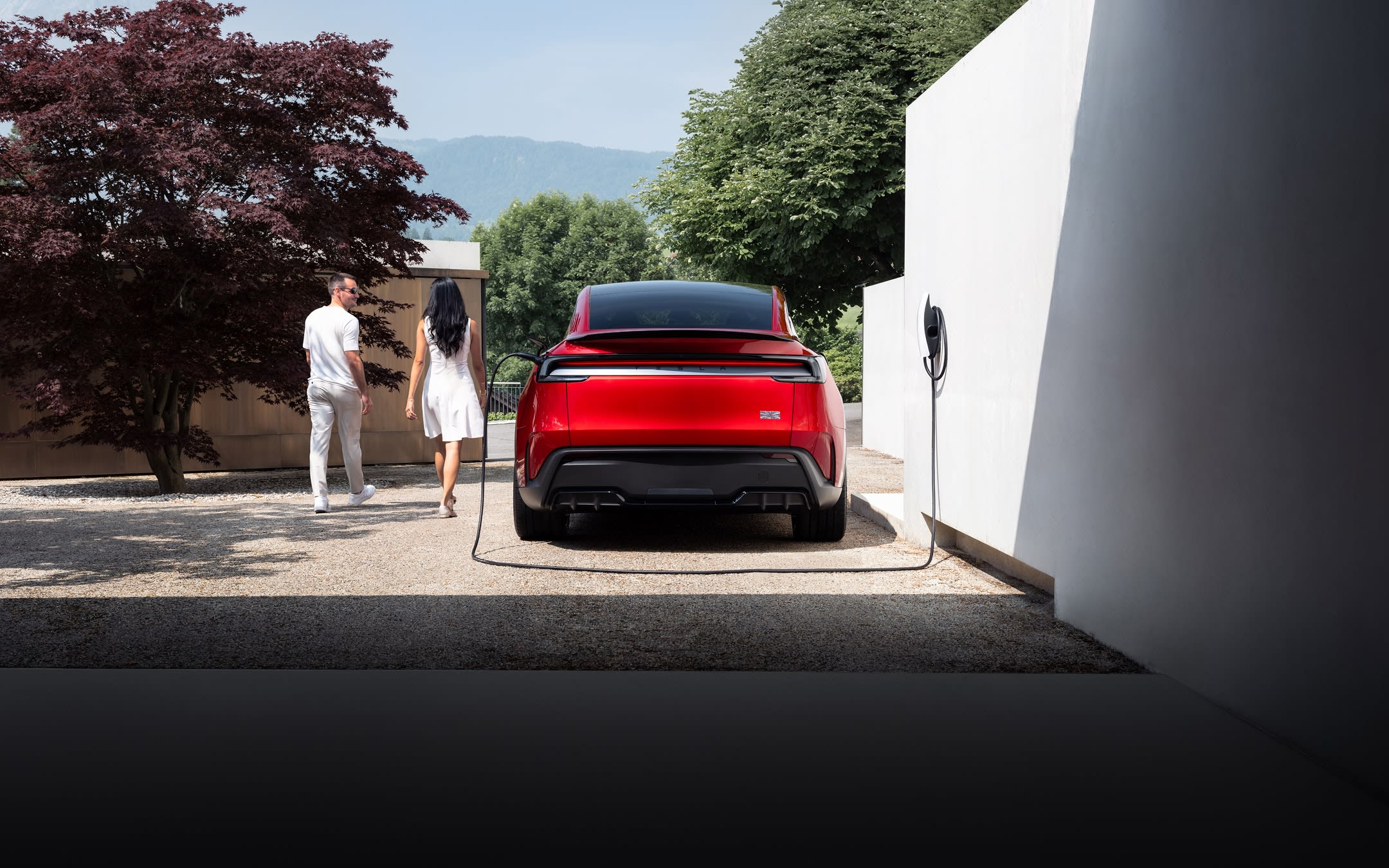 Red Model Y charging at a Wall Connector
