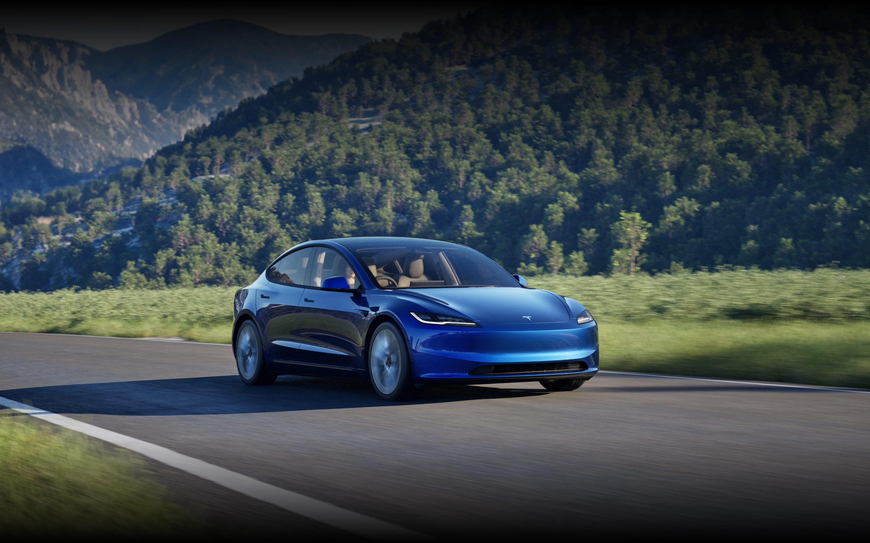 Ultra Red Model 3 roaming down a road with cityscape in the background.