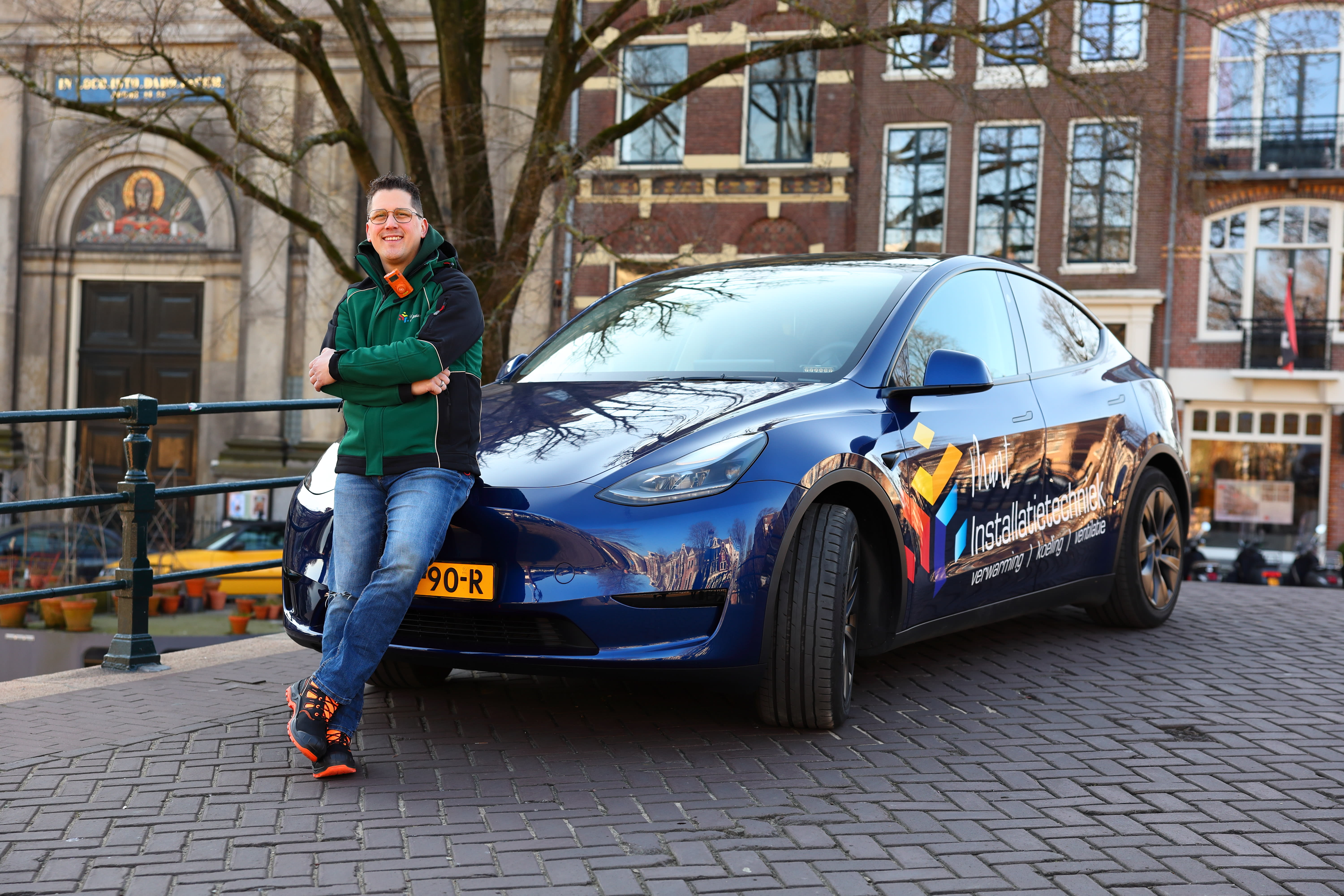 A deep blue metallic Model Y parked on the street