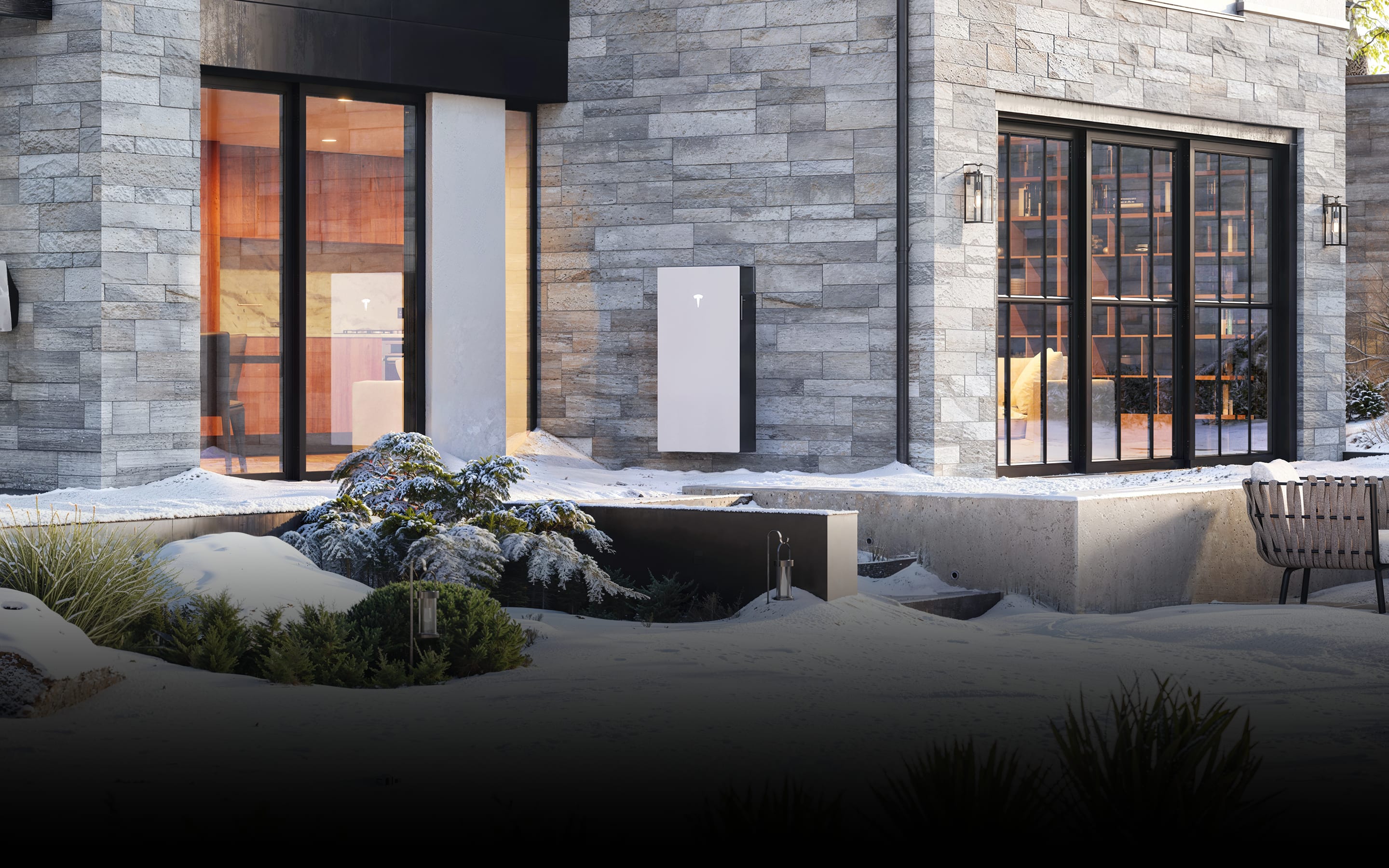 Vue d'une maison avec de la neige dehors et un Powerwall 3 installé