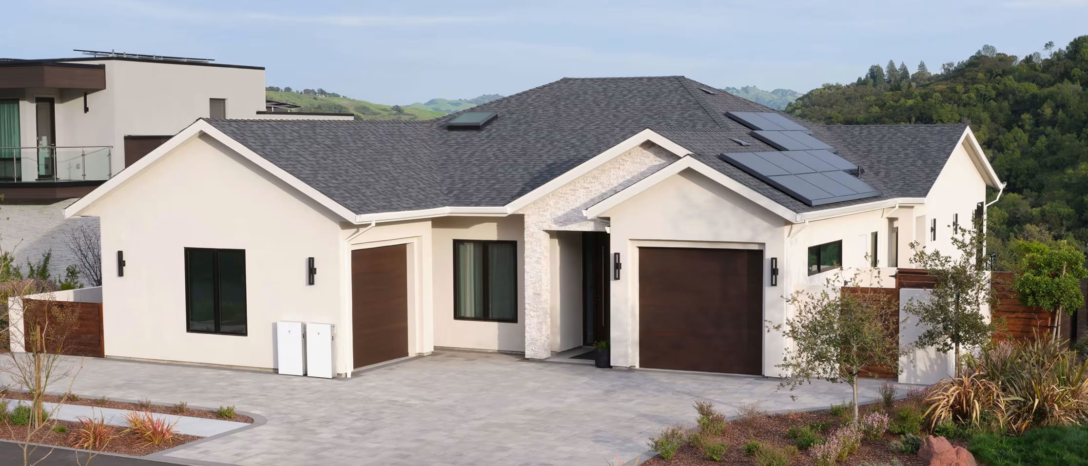 Aerial shot of a white home with solar panels at night