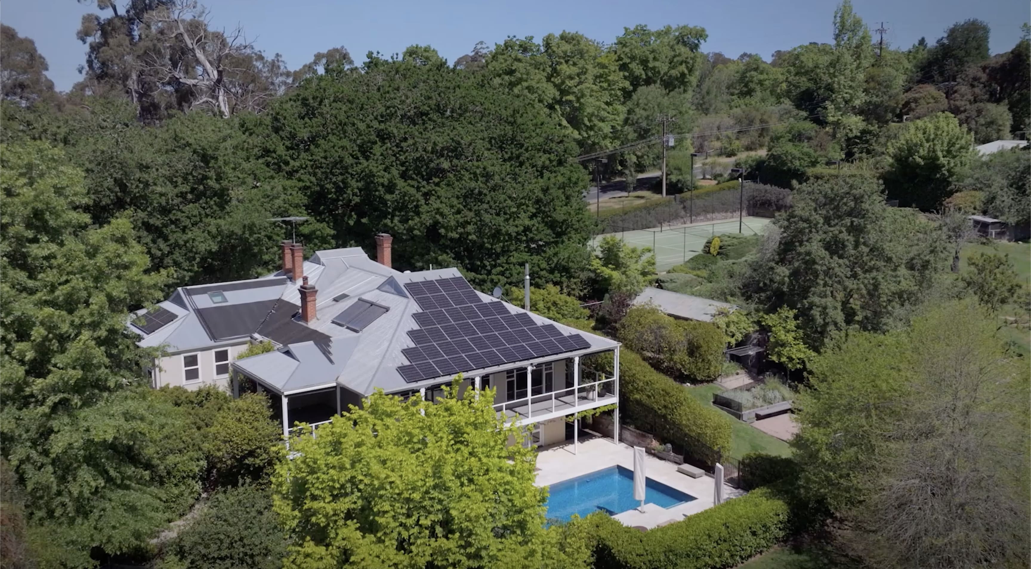 Aerial view of a home with a pool and trees in Australia