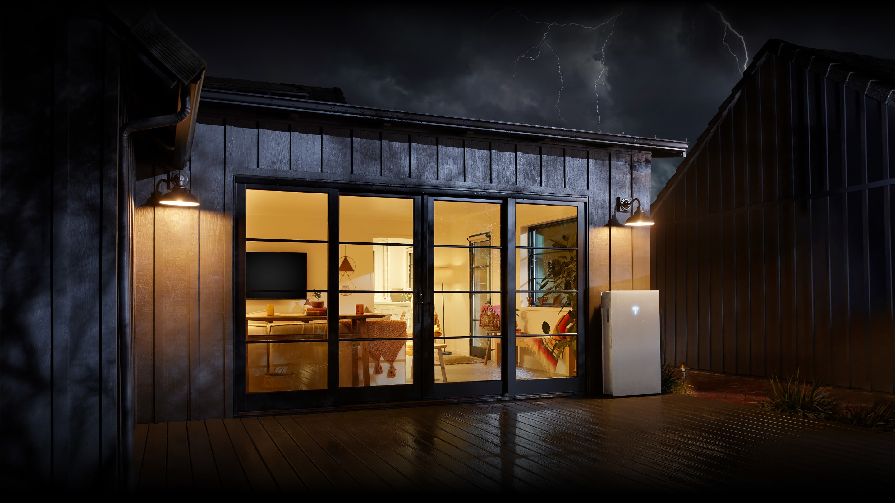 View of Powerwall 3 outside of a home with lights on