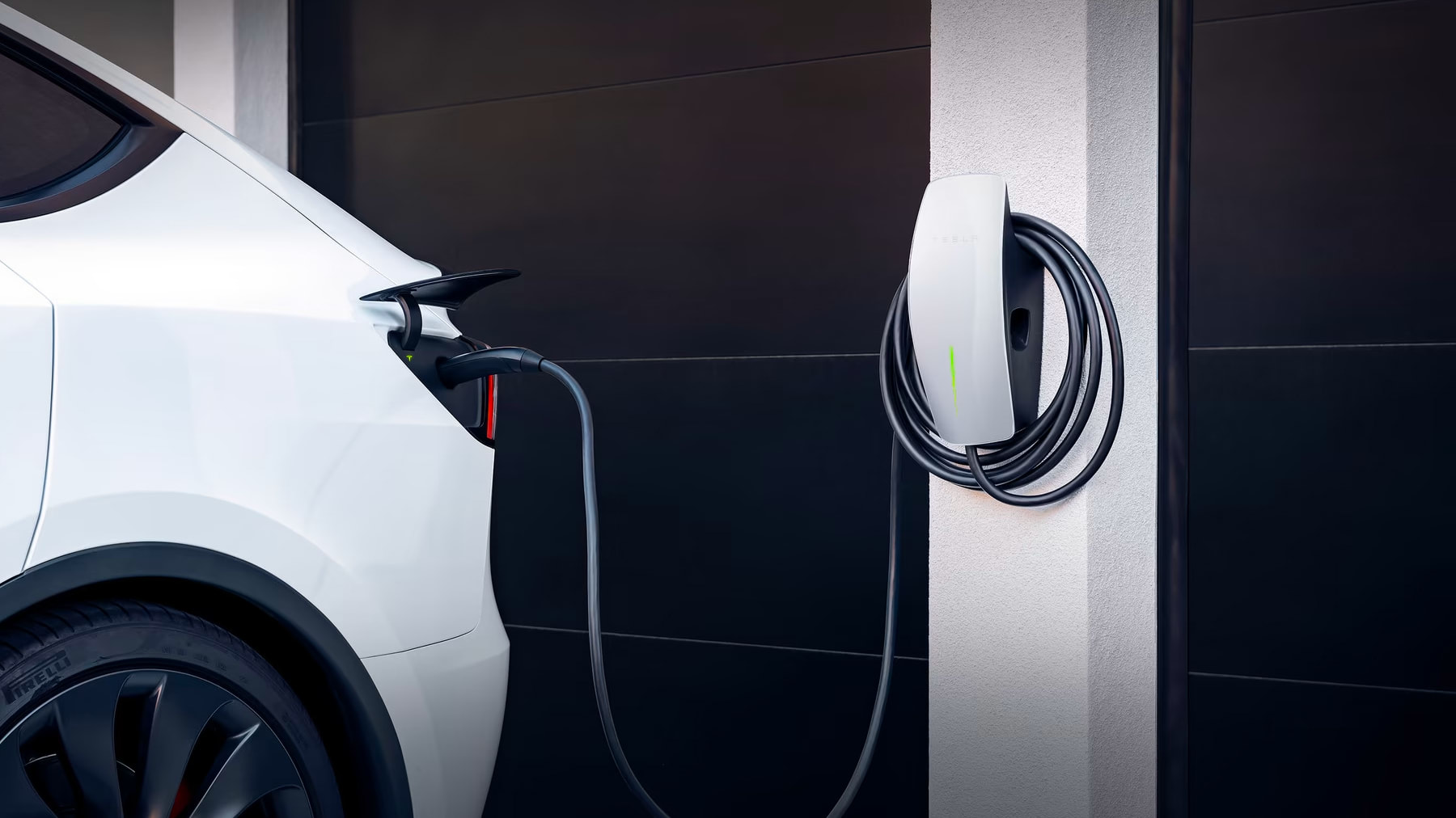 White Model Y Charging with a Wall Connector