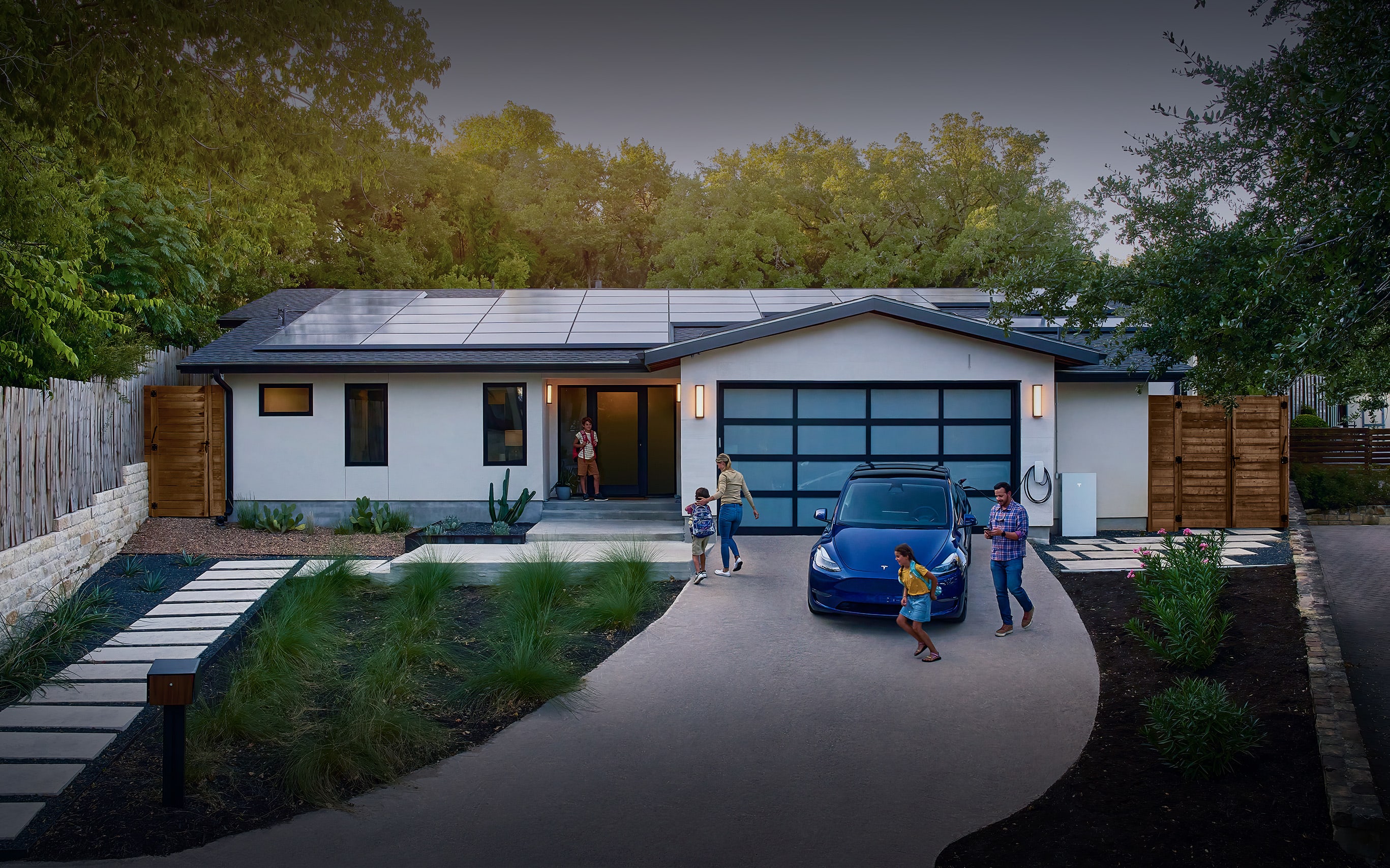 Family entering home equipped with solar panels, Wall Connector and Powerwall 3