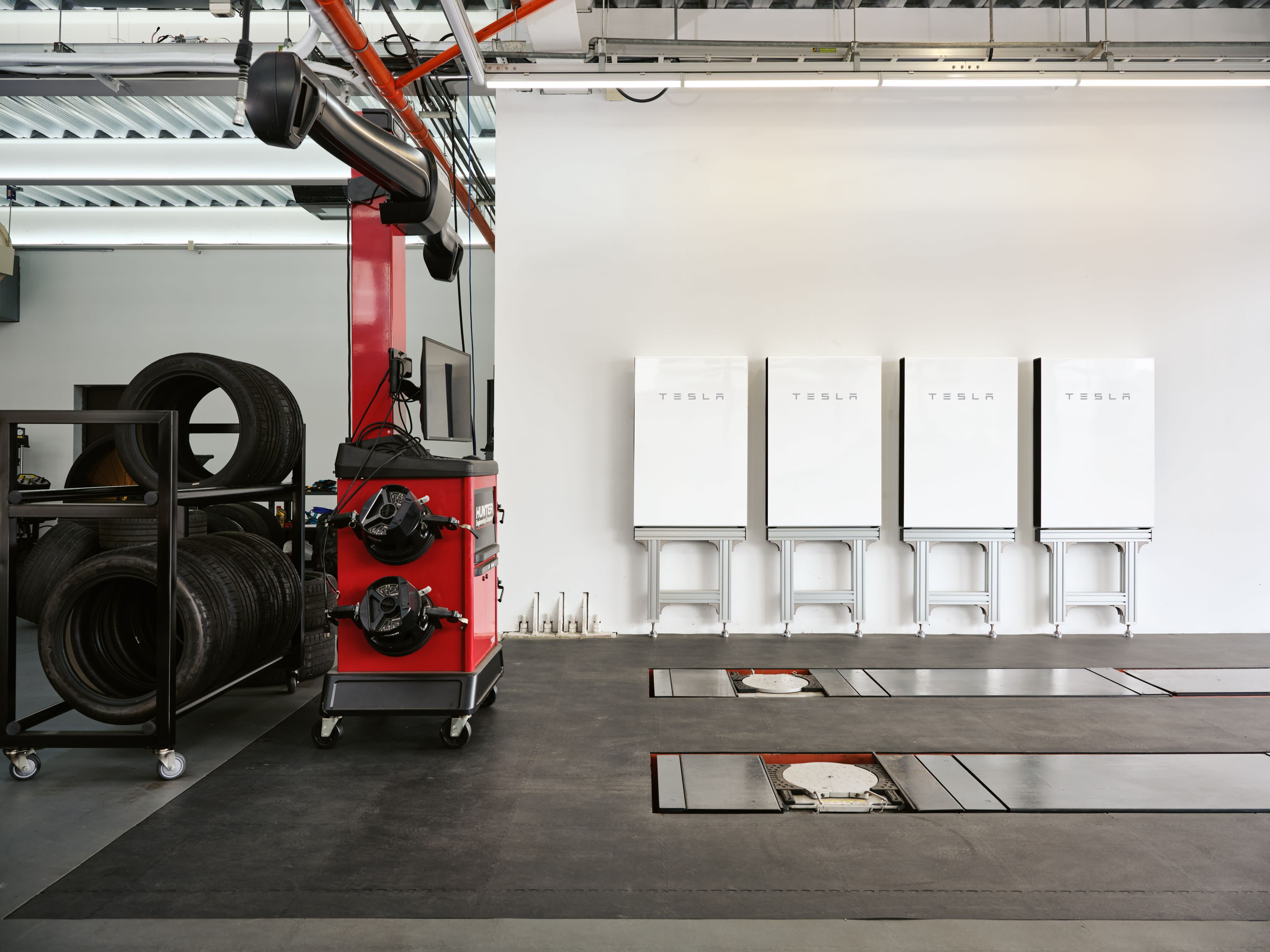 銷售中心的牆壁上安裝了四台白色 Tesla Powerwall