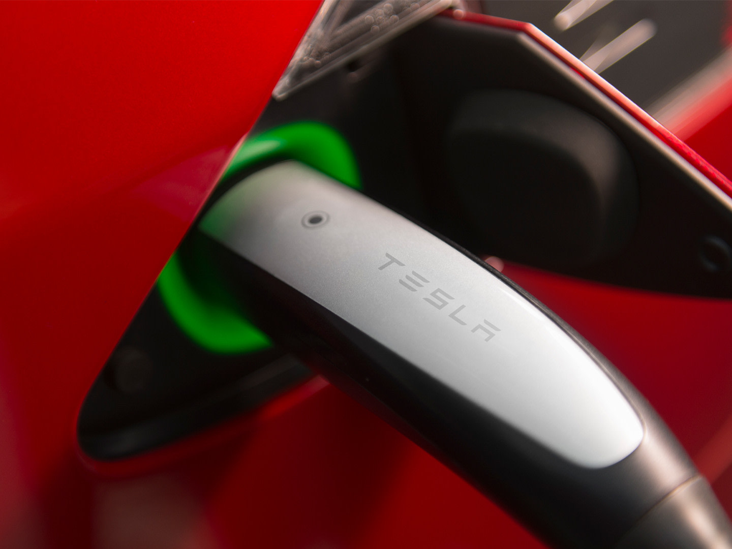 Supercharger plugged into a Tesla charge port