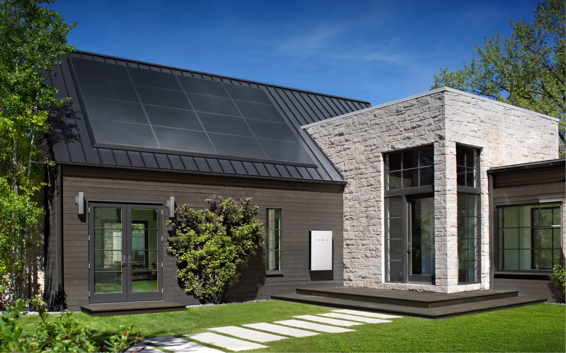 House with Tesla Powerwall and solar panels on the roof