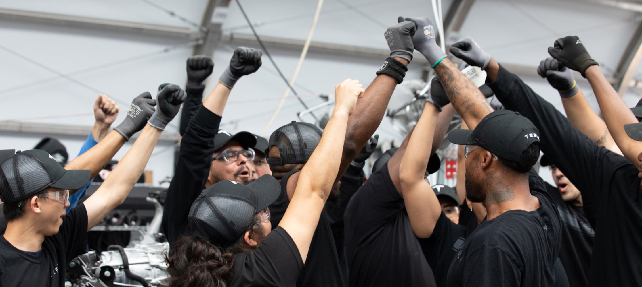 Tesla employees uniting at the factory. 