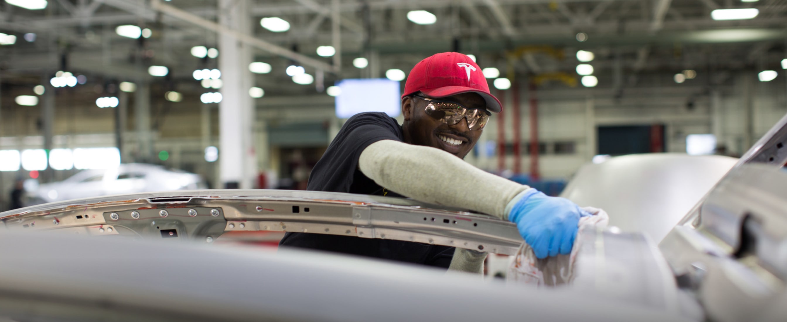 Tesla employee working in factory.