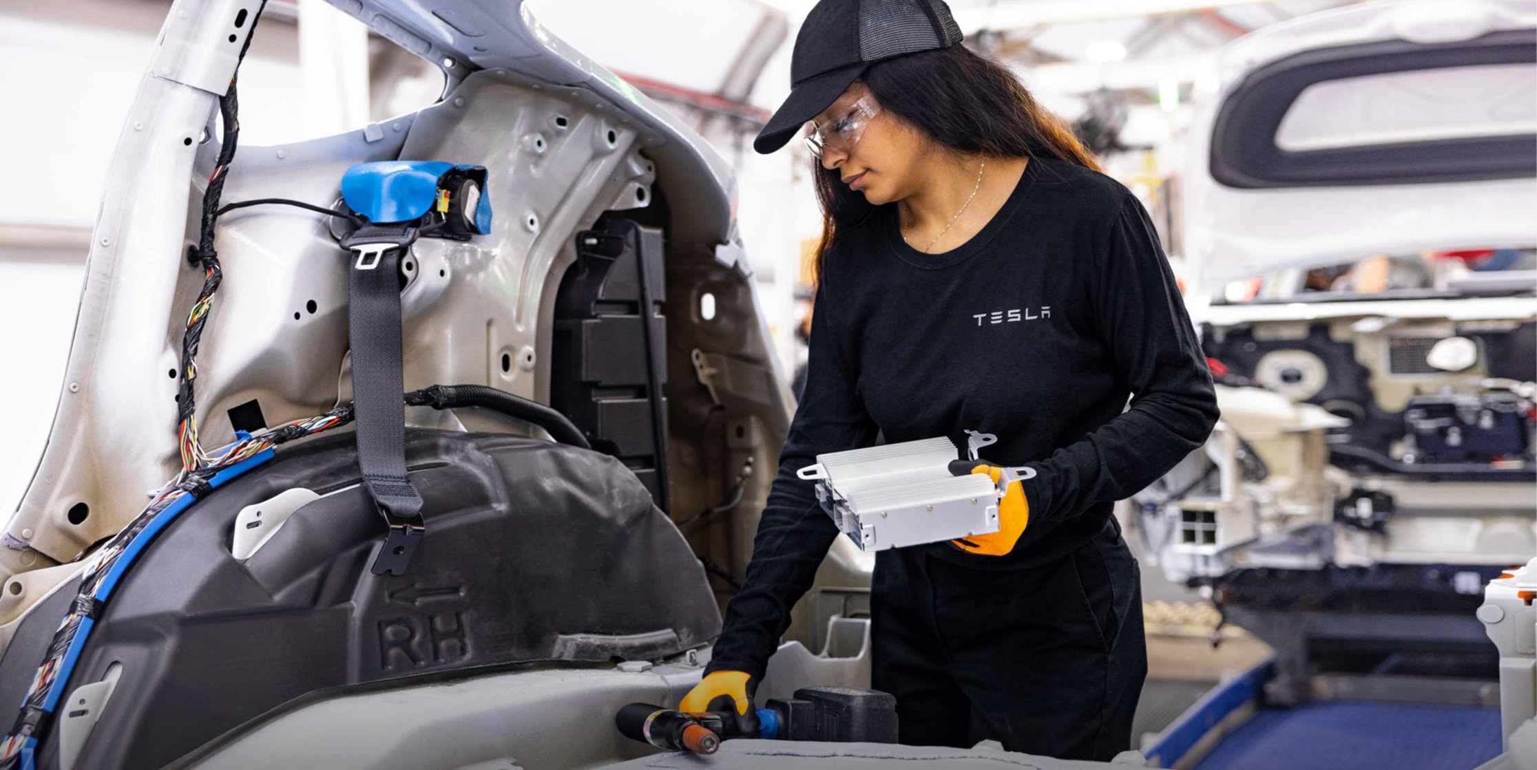 Tesla employee working in factory.