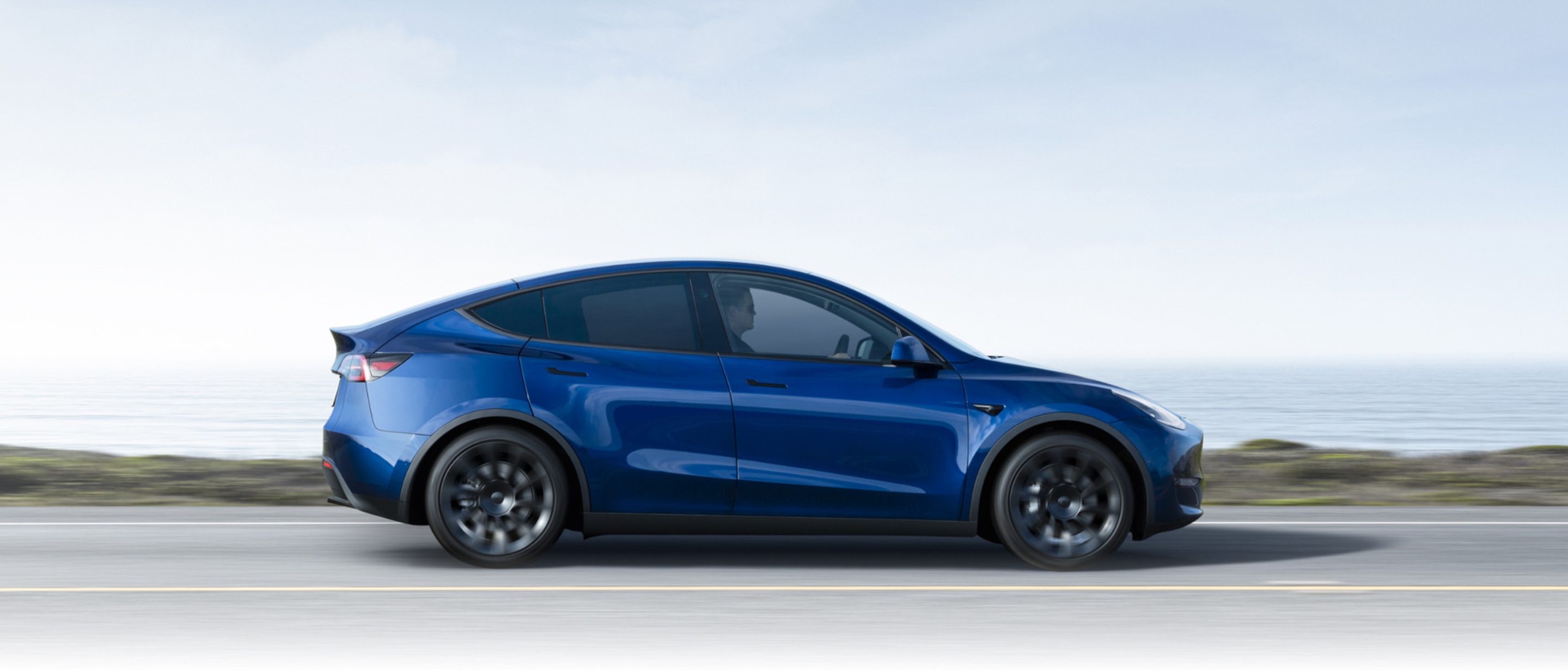 Una Tesla blu che viaggia in autostrada