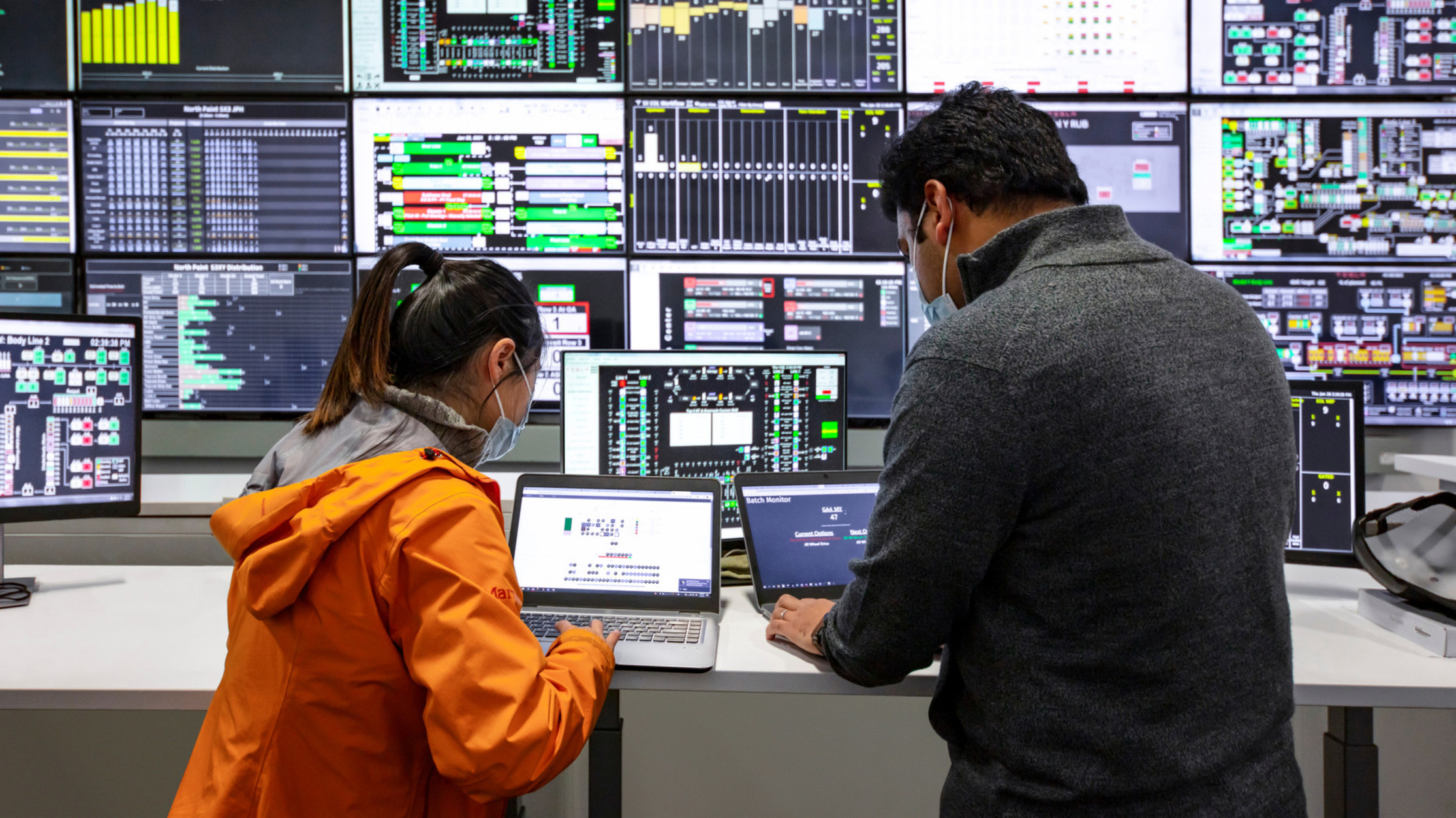 Three Tesla employees collaborating