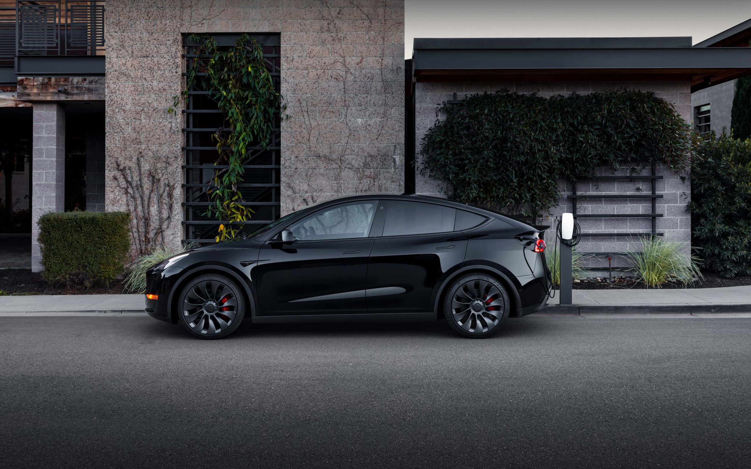 Black Model Y charging via Wall Connector