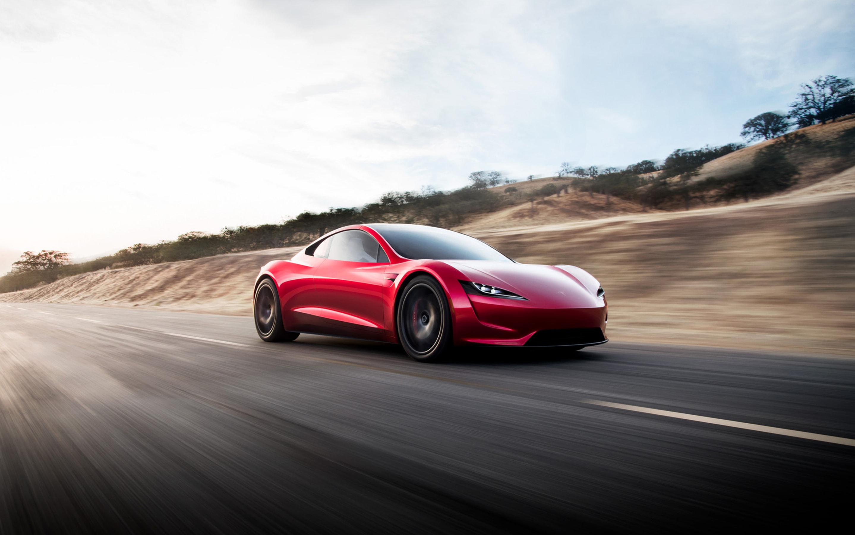 Red Roadster on paved street