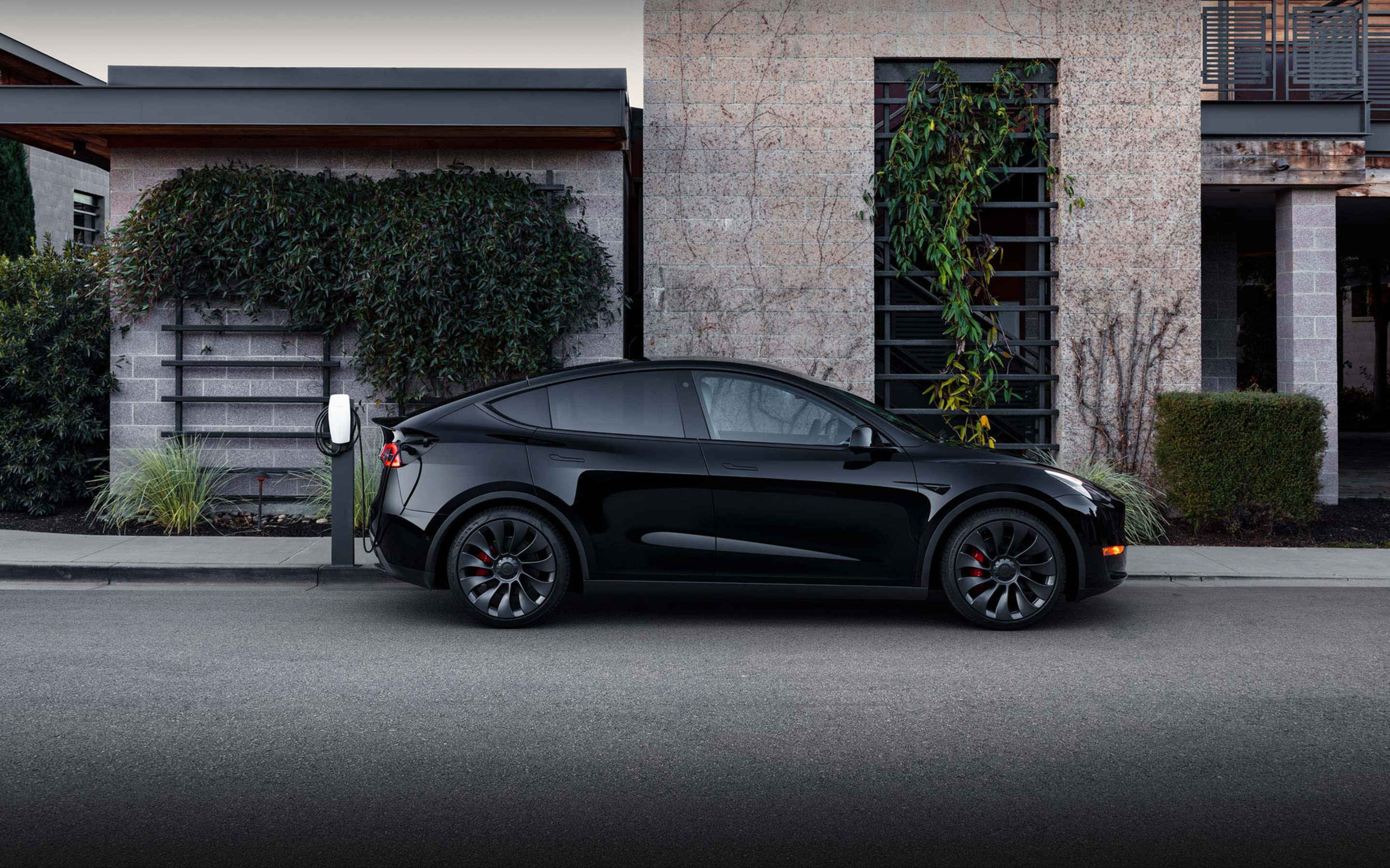 Black Model Y charging via Wall Connector