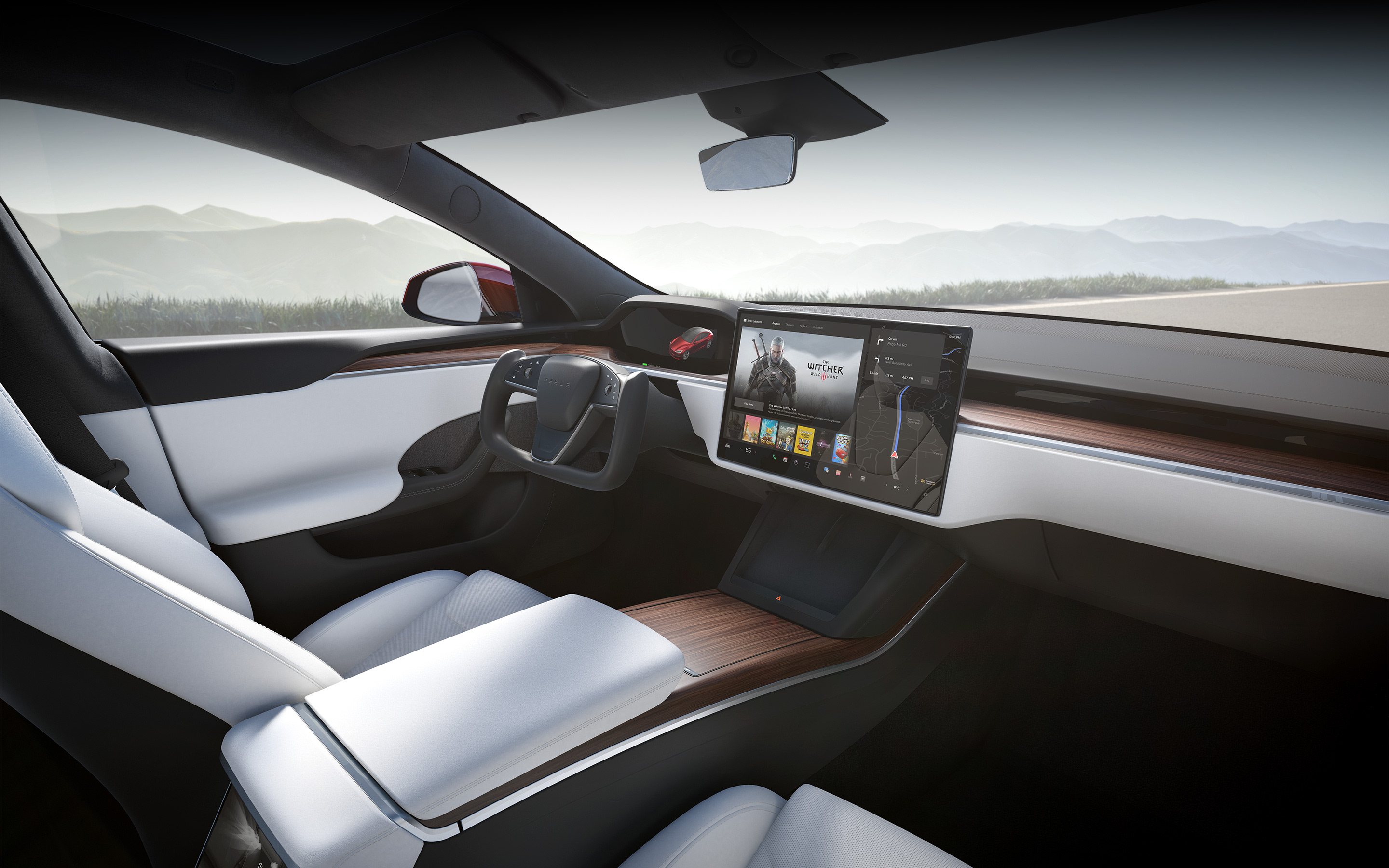 Model S con interior blanco desde el punto de vista del asiento del pasajero con el foco puesto en la pantalla táctil de infoentretenimiento