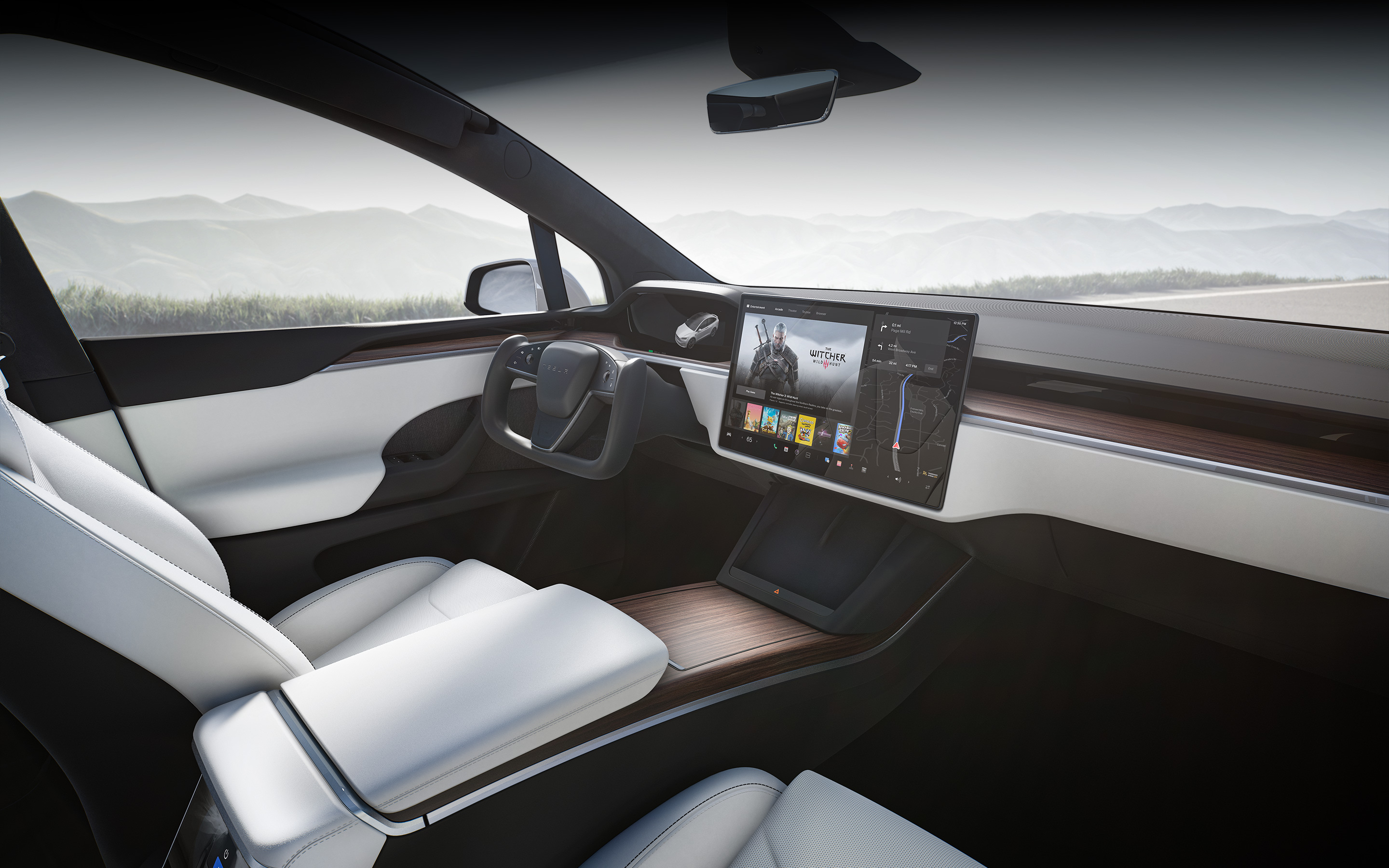 Model X com interior branco do ponto de vista do banco do passageiro, com foco no ecrã tátil do sistema de informação e entretenimento