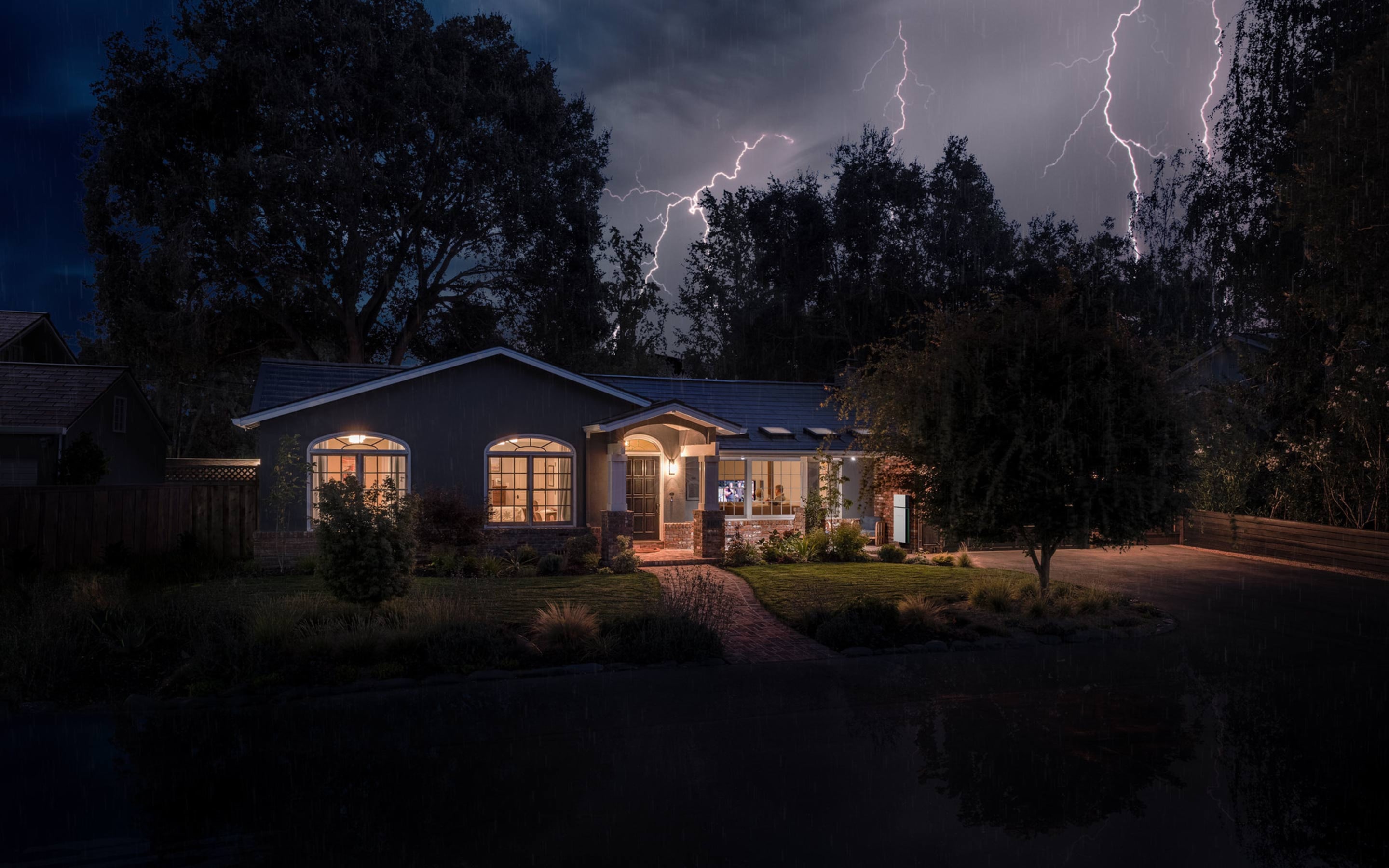 Home with Tesla Solar Roof and Powerwall in a storm