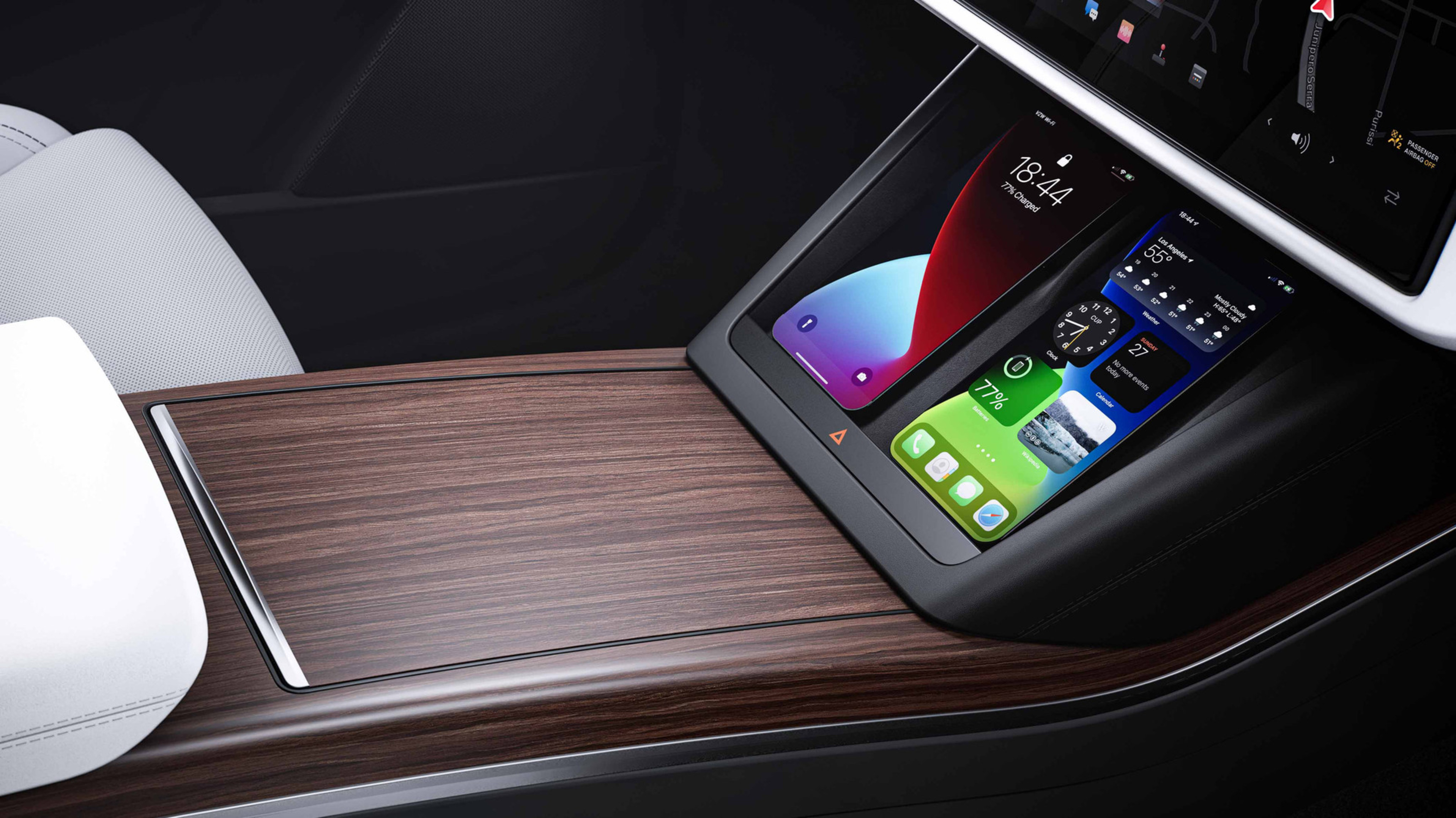 Interior shot from the passenger seat point of view of the console showing two smartphones charging wirelessly